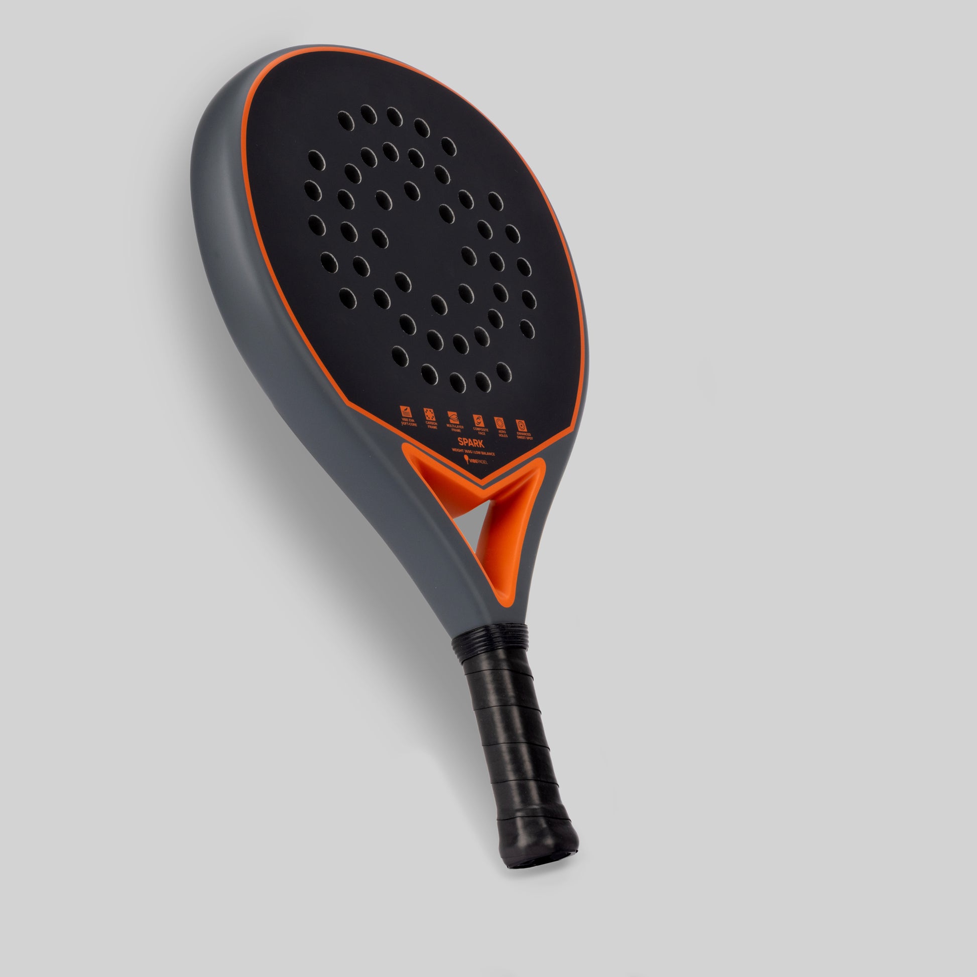 Gray and orange padel racket for beginner on a light gray background